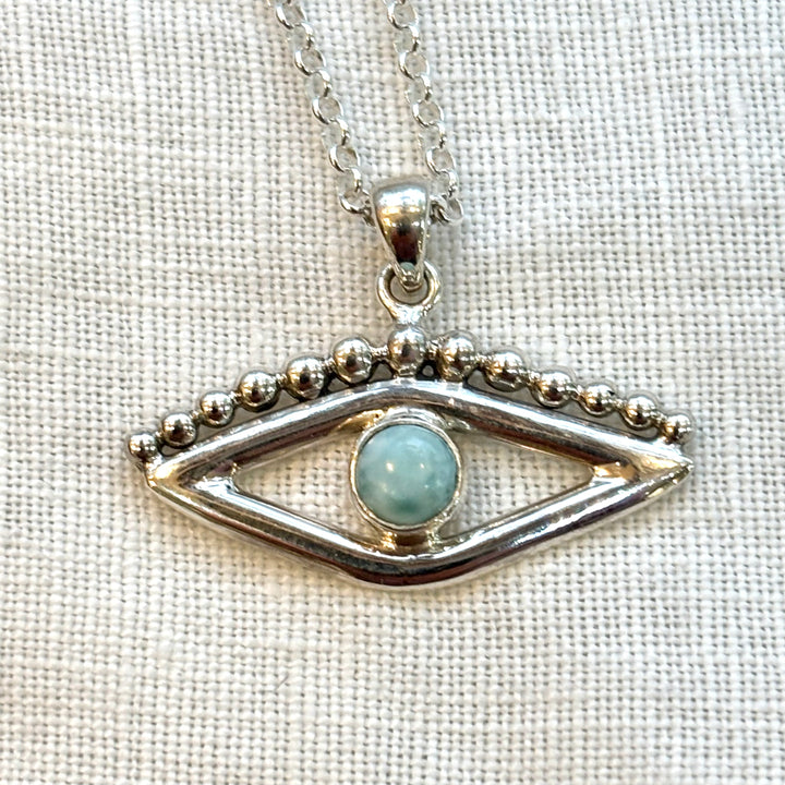 Full length view of a handmade sterling silver larimar evil eye necklace showing the complete 18 inch chain and pendant drop