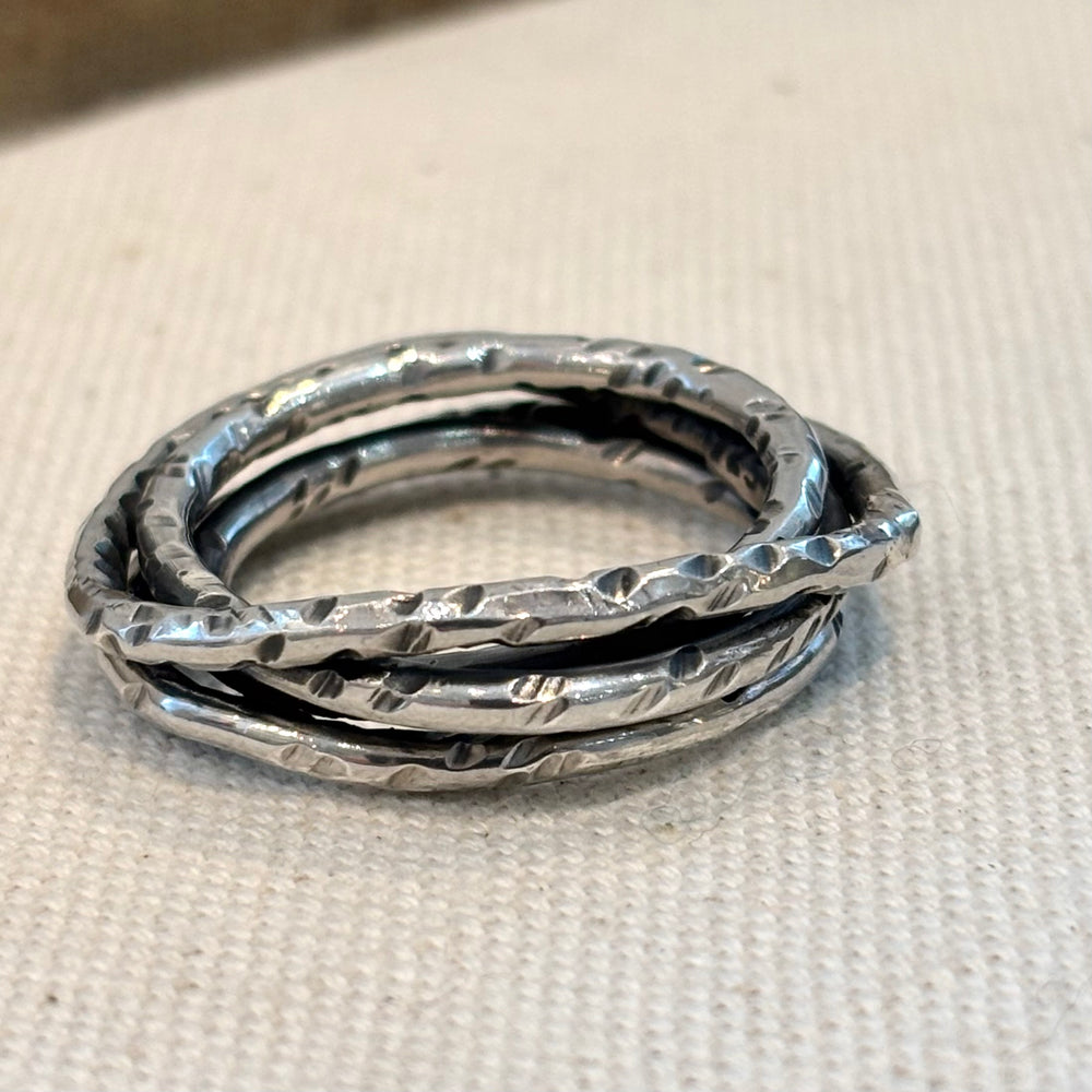 Hand textured woven sterling silver ring with layered wave form and organic surface finish