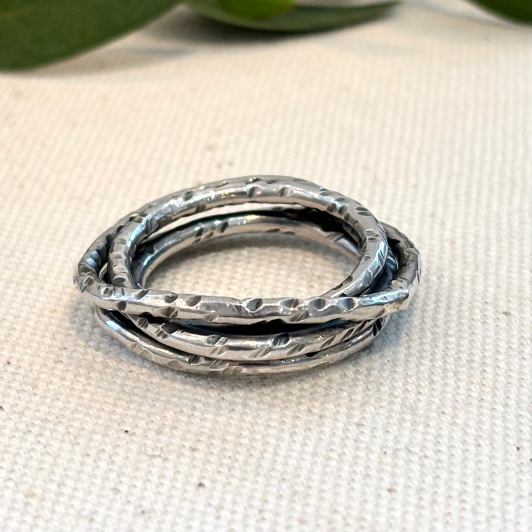Hand textured woven sterling silver ring with layered wave form and organic surface finish