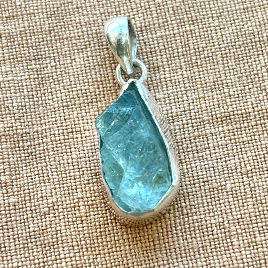 Full length view of a raw aquamarine crystal sterling silver necklace showing the complete 18 inch chain and organic pendant drop